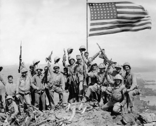 Mitchell native Jack Thurman is shown at the far left, waving his cap, in Joe Rosenthal s famous World War II photograph. Click to enlarge photo.
